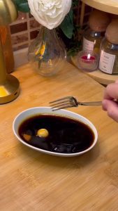 Dipping the dough balls into the molasses and water mixture for flavor