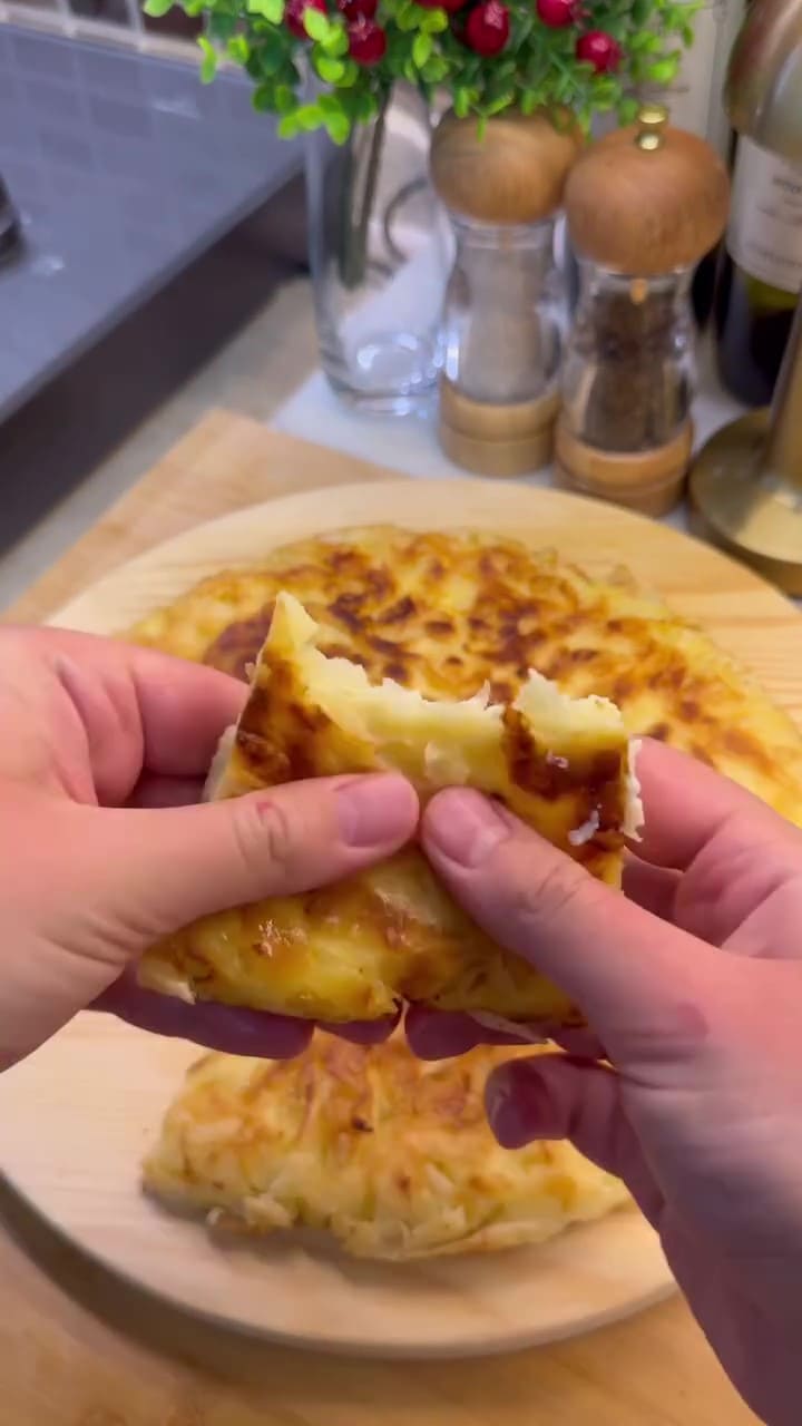 A golden-brown, crispy Turkish pan borek served in wedges on a plate.