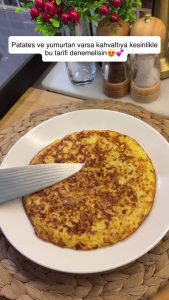 The final 2-ingredient crispy potato omelet served hot on a breakfast plate.