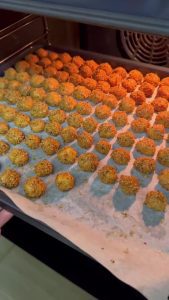 Golden-brown, crunchy Turkish sesame cookies served with a glass of tea.