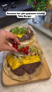 The final result: A crispy, folded smash taco burger with melted cheese and fresh garnish.