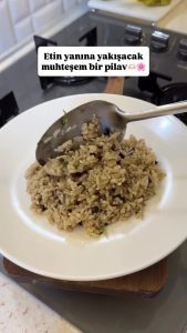 The final presentation of fluffy, grainy Turkish aromatic pilaf ready to be served on a plate.