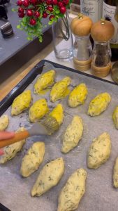 Folding the dough over the cheese filling to create a traditional half-moon shape.