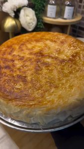 Frying the Adana Böreği on a low-heat stovetop until crispy and golden.