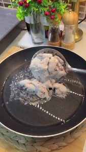 Frying the spiced chicken livers in a hot skillet until they turn crispy and golden.
