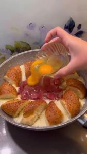 Sautéing the sucuk slices until they are cooked and have released their aromatic oils.