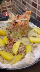 Frying the chicken and potatoes until they reach a deep golden brown color.