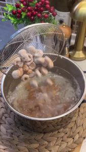 Pressing a small dimple into the center of each bulgur ball using a finger.
