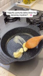 Melting a tablespoon of butter in a non-stick skillet for Turkish yogurt eggs.