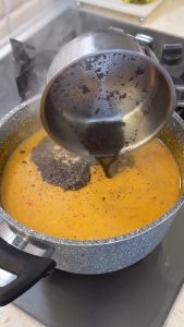 Melting butter and adding dried mint in a small pan for the aromatic garnish.