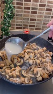 Adding a splash of starchy pasta water to the sautéed chicken and mushrooms.