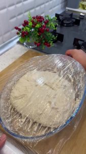 Repeating the folding process to build structure and elasticity in the no-knead dough.