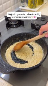 Stirring yogurt until the water evaporates and it reaches a crumbly, cheese-like texture.