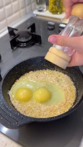 Gently scrambling the eggs and mixing them with the cheese-like yogurt base.