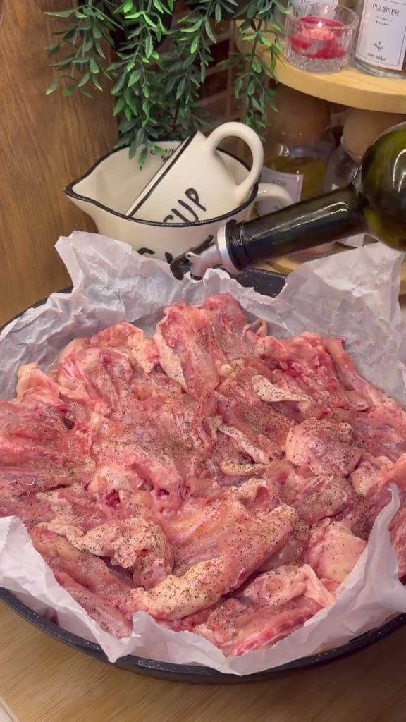 Seasoning chicken butterfly pieces with salt, oil, and lots of black pepper.