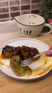 Plating the eggplant beyti over garlic yogurt with a drizzle of red pepper butter.