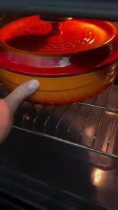 Baking the lamb and vegetable tray in a 200 degree oven.