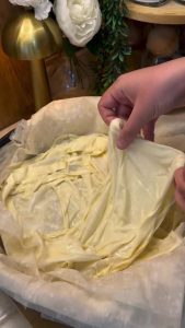 Dipping pieces of standard yufka dough into the milk and egg mixture.