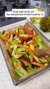 Spreading the coated vegetables in a single layer on a parchment-lined baking tray.