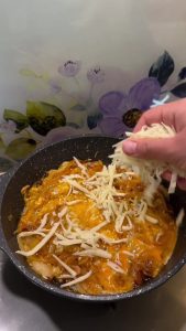 Adding a layer of grated Kaşar or mozzarella cheese over the cooked eggs and onions.