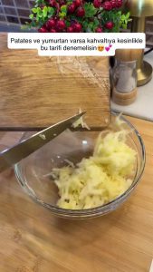 Squeezing out excess starch and water from grated potatoes by hand for extra crispiness.