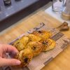 A tray of golden brown Turkish dill and cheese pastries sprinkled with black cumin seeds.