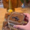 Creamy layered Turkish milk pudding cups with crumbled cake base and glossy chocolate ganache topping.