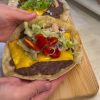 A delicious viral smash taco burger with melted cheddar cheese, lettuce, and sauce.