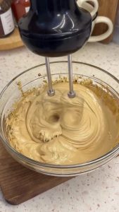 Beating the honey and coffee mixture for 5 minutes until it forms a thick, stable foam.