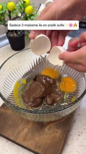 Whisking chocolate hazelnut spread and fresh eggs in a bowl.