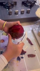 Grating a fresh red beet for a Turkish meze.