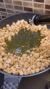 Adding vegetable oil and paprika to the center of the pan.