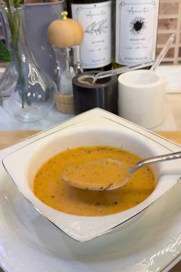 A bowl of creamy Turkish yogurt soup with a savory minced beef and red pepper base.