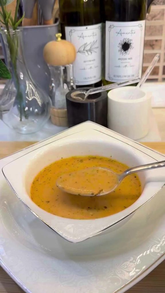 A bowl of creamy Turkish yogurt soup with a savory minced beef and red pepper base.