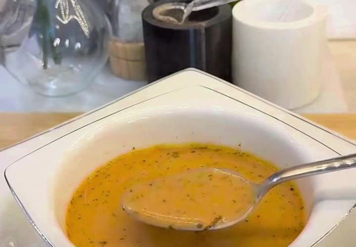 A bowl of creamy Turkish yogurt soup with a savory minced beef and red pepper base.