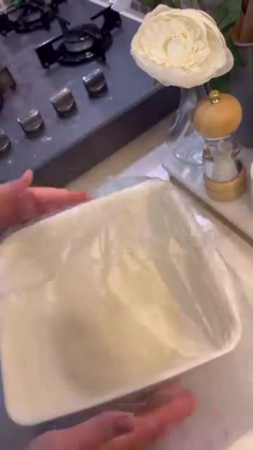 Resting gözleme dough in a bowl covered with a towel.