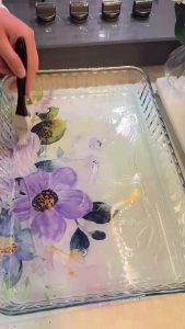 Placing shredded yufka strips in a greased baking pan.