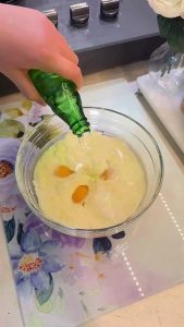 Whisking eggs, milk, and sparkling water for a borek sauce.