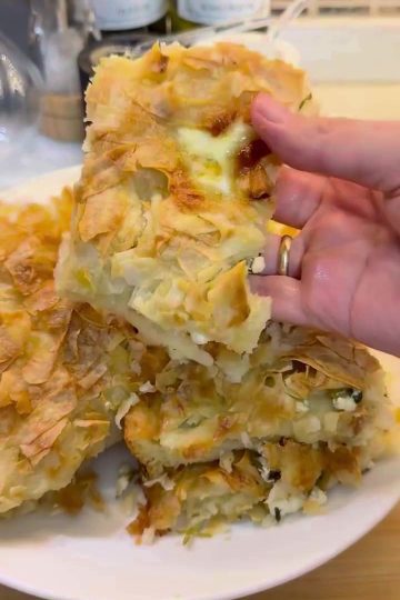 A golden-brown tray of Lazy Su Böreği sliced into squares.