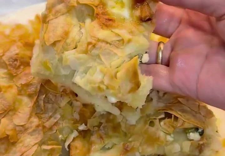 A golden-brown tray of Lazy Su Böreği sliced into squares.