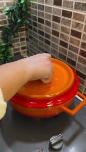 Simmering Turkish meat pasta on a low stovetop setting.