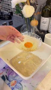 Whisking yeast, sugar, and milk in a large mixing bowl.