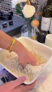 Kneading a soft yeast dough by hand for mini pizzas.