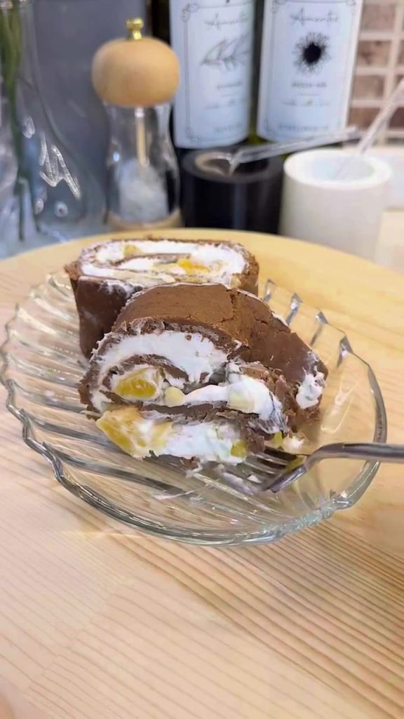 Slicing a cold no-bake biscuit log cake for serving.