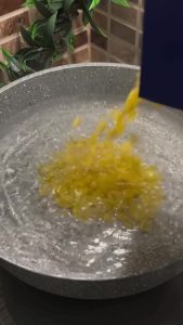 Boiling pasta in a pot for a Turkish yogurt salad.