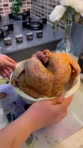 Adding cubed potatoes and onions to a bundt cake pan.