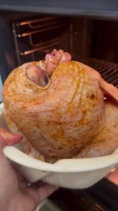 Roasting a vertical chicken in a preheated 400 degree oven.