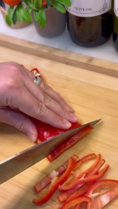 Chopping onions and peppers for roasted chickpeas.