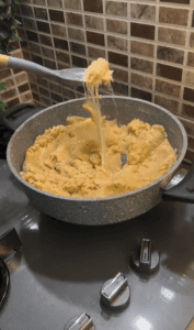 Serving a bowl of hot cheesy Turkish semolina halva.