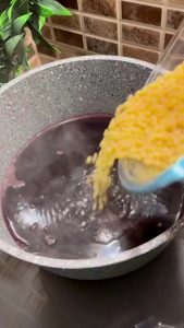Adding Turkish pearl couscous to the boiling shalgam juice.